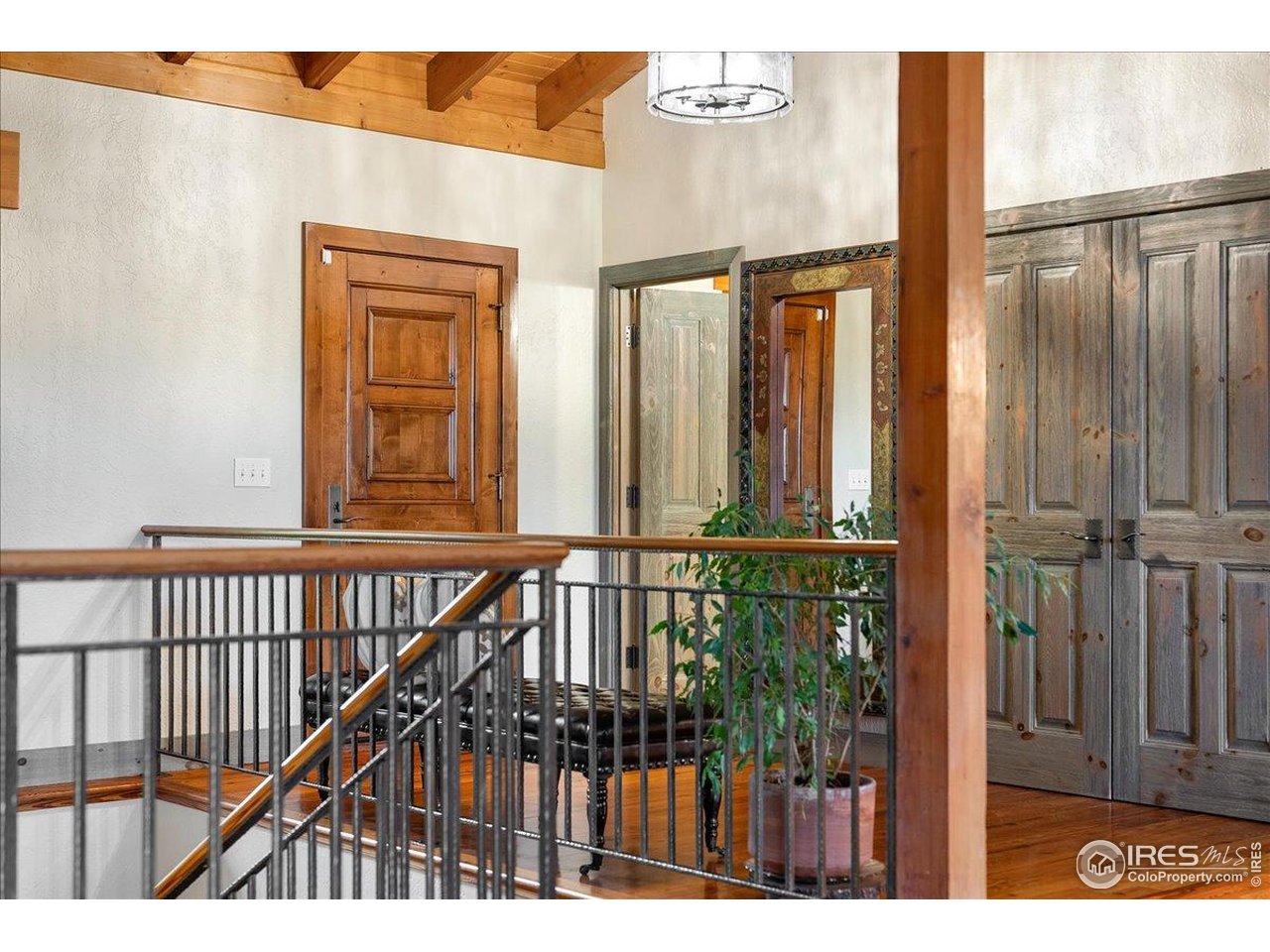 960 Ridge W Drive Windsor, CO 80550 - Photo 14 of 50 a view of staircase with railing and a chandelier