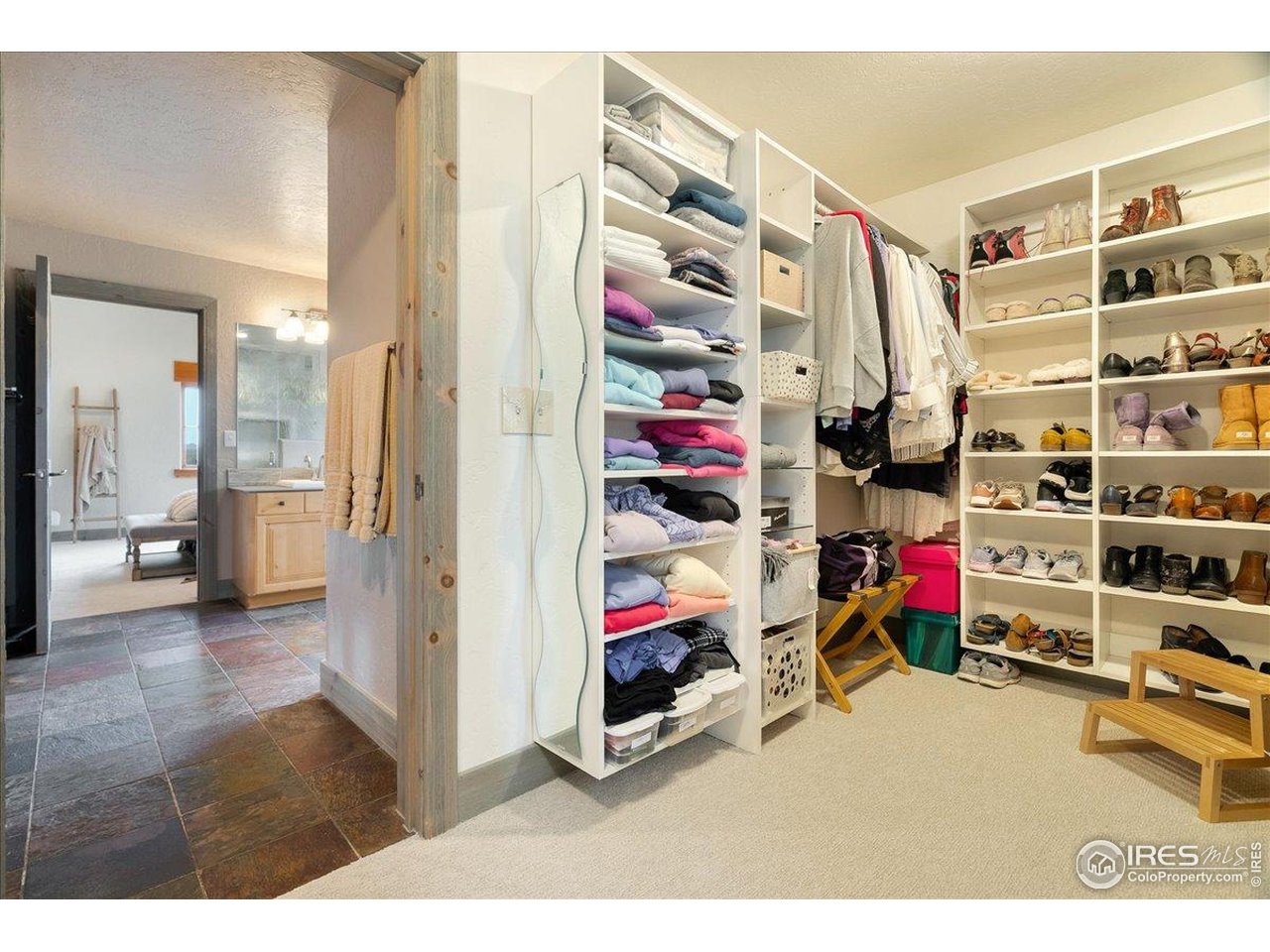 960 Ridge W Drive Windsor, CO 80550 - Photo 26 of 50 a view of a bedroom with clothes and shoes