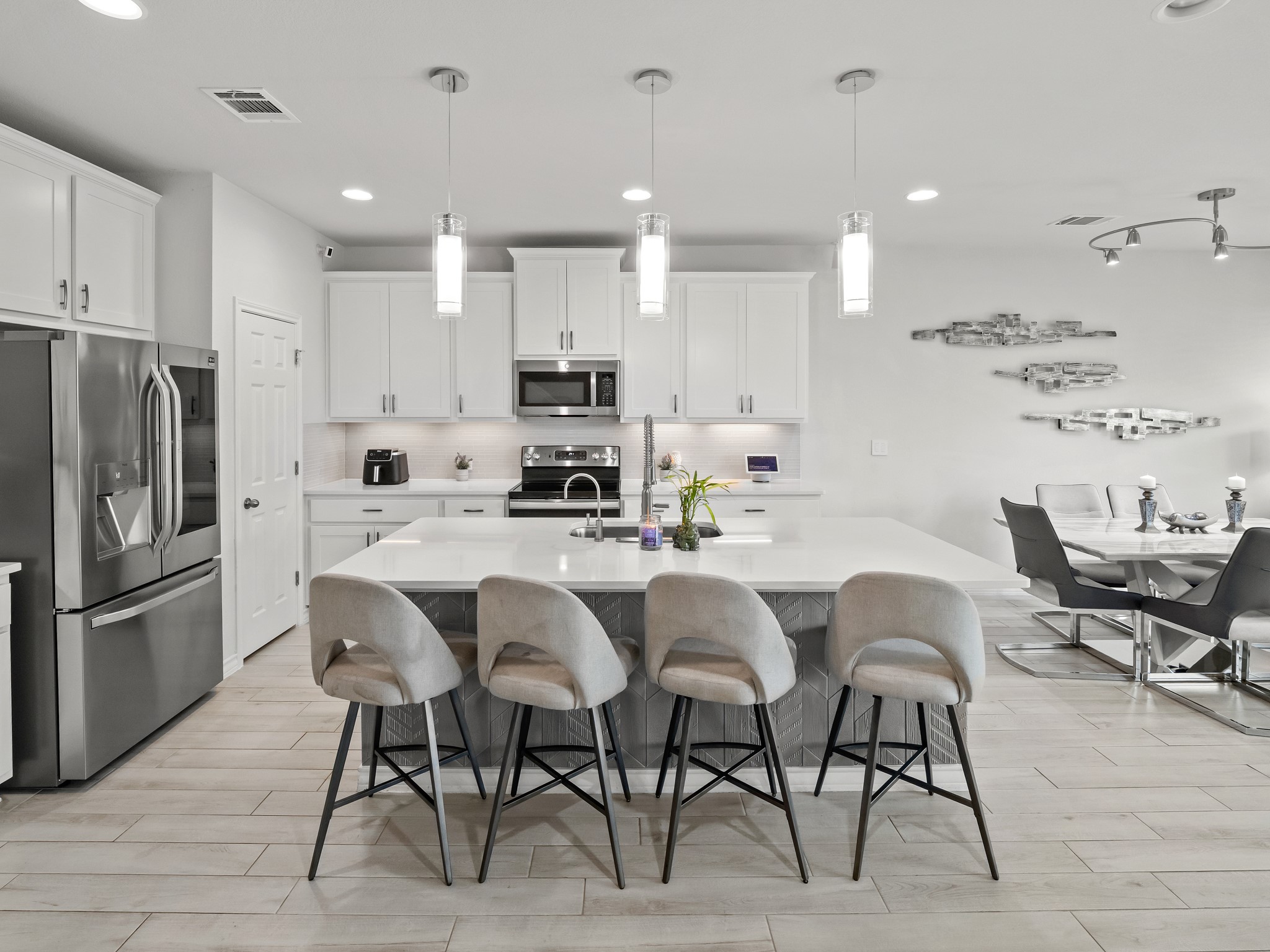 353 Capstone Road Liberty Hill, TX 78642 - Photo 5 of 28 Culinary excellence awaits in this well-appointed kitchen with an oversized island and seamless dining integration.