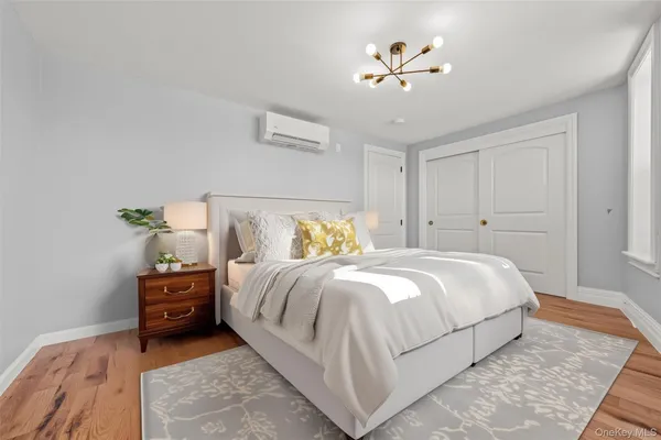 a bedroom with a bed and a chandelier