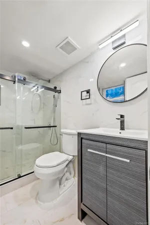 a bathroom with a sink toilet and mirror