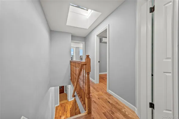 a view of kitchen and hallway with wooden floor