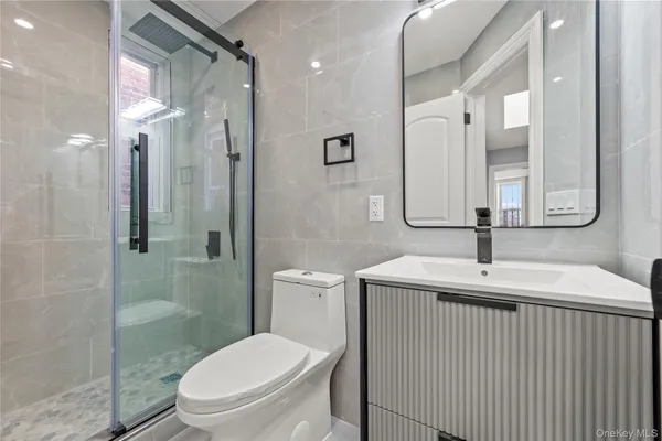 a bathroom with a sink toilet and shower