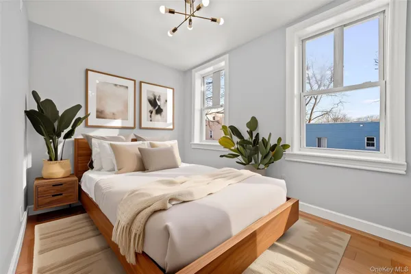 a bedroom with a large bed and a chandelier