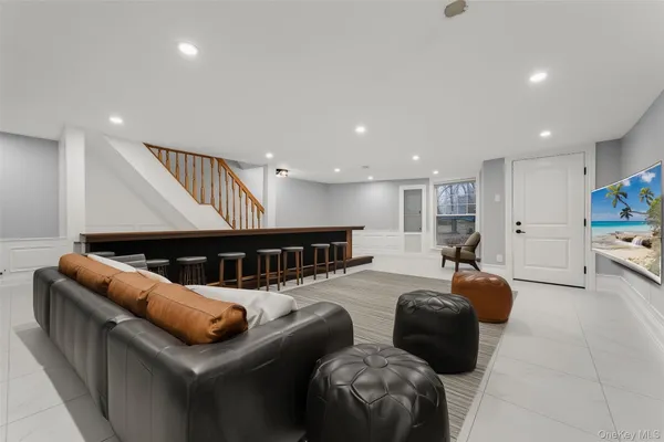 a living room with furniture and a ceiling fan