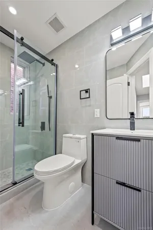 a bathroom with a toilet a sink and shower