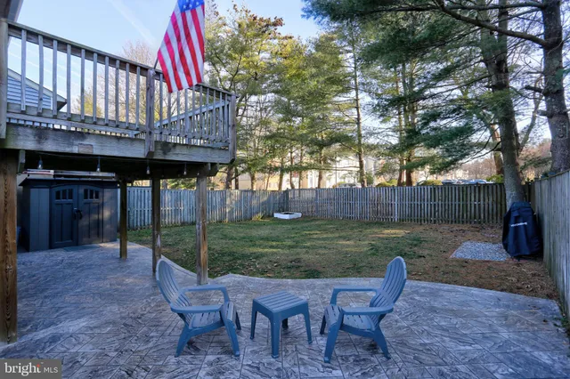 a view of a wooden dinning table and chairs in the patio