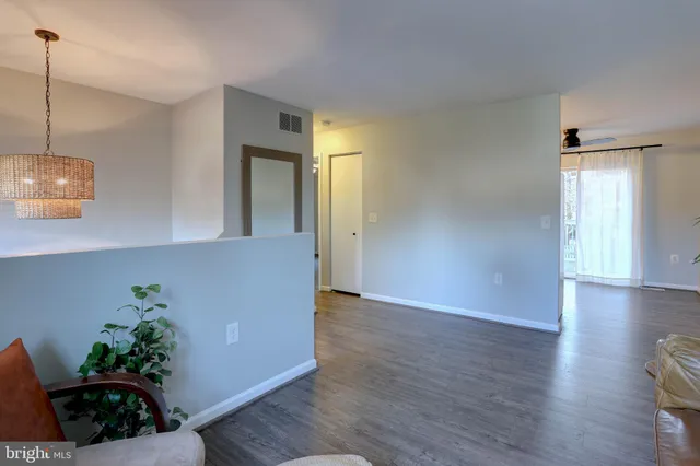 a view of a room with wooden floor and potted plant