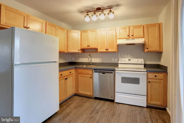a kitchen with stainless steel appliances a refrigerator sink and cabinets