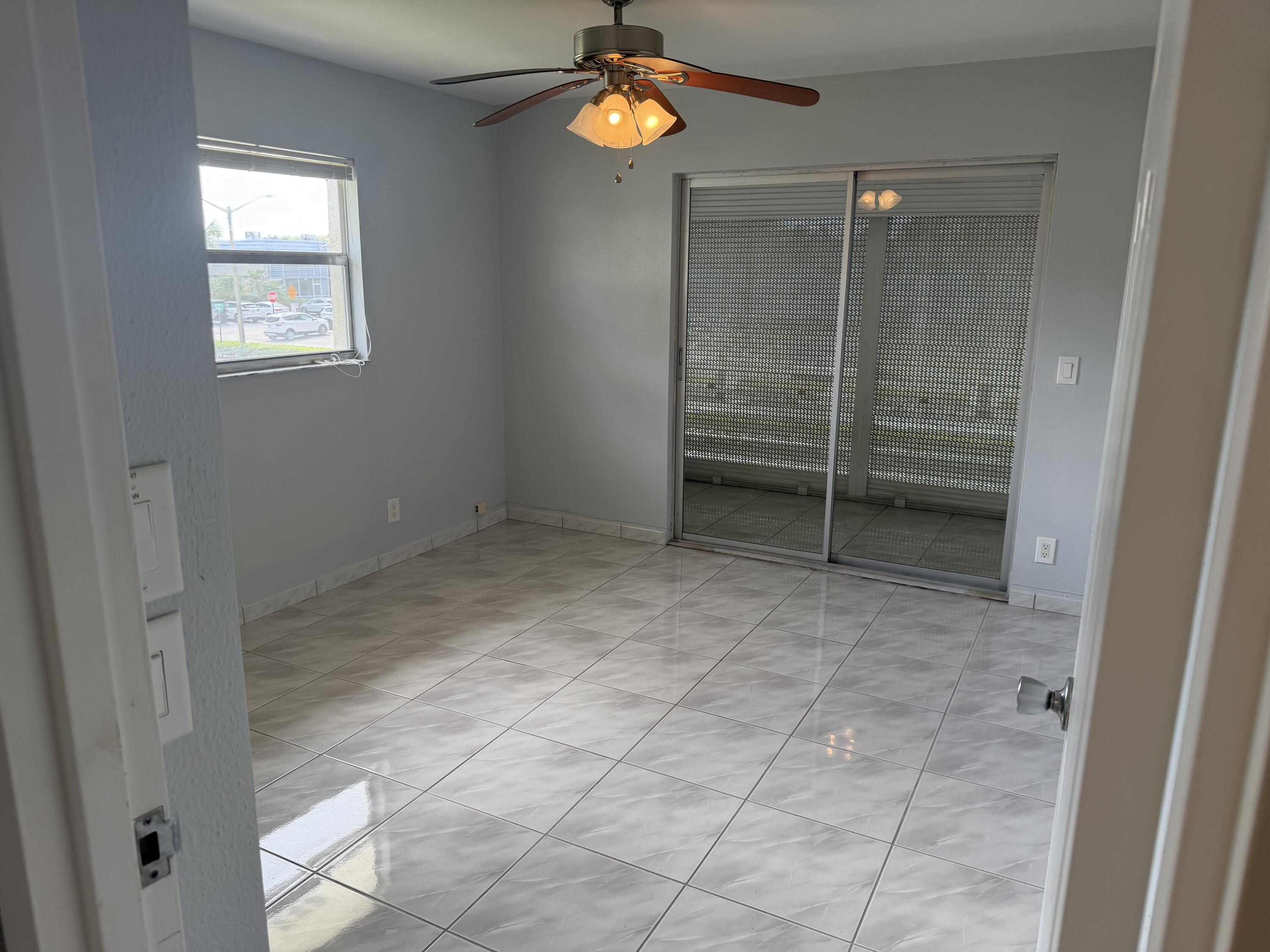 373 Monaco Way, Unit H Delray Beach, FL 33446 - Photo 3 of 9 a view of an empty room with a window