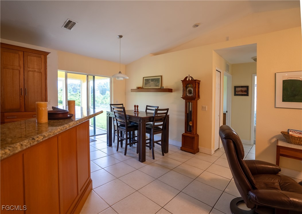 2516 13th Street Southwest Lehigh Acres, FL 33976 - Photo 13 of 16 a dining room with furniture and window