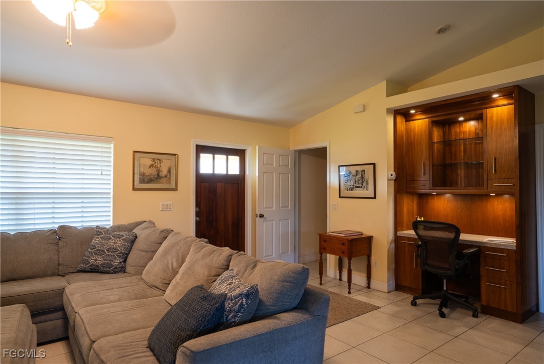 2516 13th Street Southwest Lehigh Acres, FL 33976 - Photo 15 of 16 a living room with furniture a lamp and a window