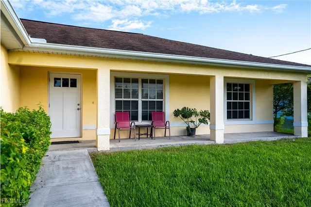 a view of a lounge chairs in front of a house