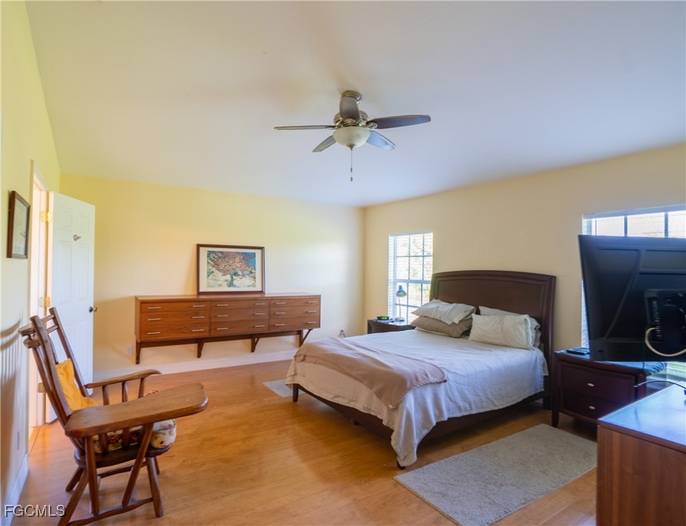 2516 13th Street Southwest Lehigh Acres, FL 33976 - Photo 5 of 16 a bedroom with a bed and wooden floor