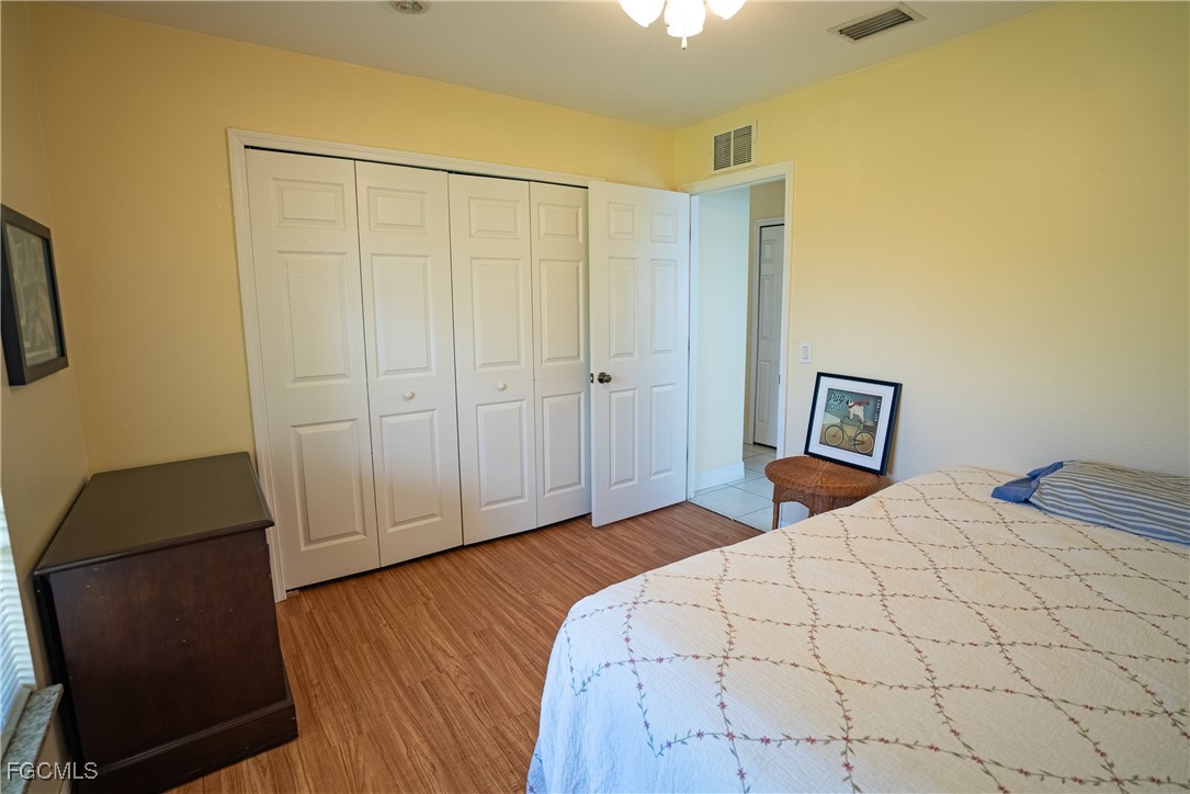 2516 13th Street Southwest Lehigh Acres, FL 33976 - Photo 8 of 16 a bedroom with a bed and a chair