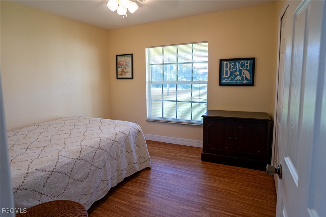 2516 13th Street Southwest Lehigh Acres, FL 33976 - Photo 9 of 16 a bedroom with a bed and a window