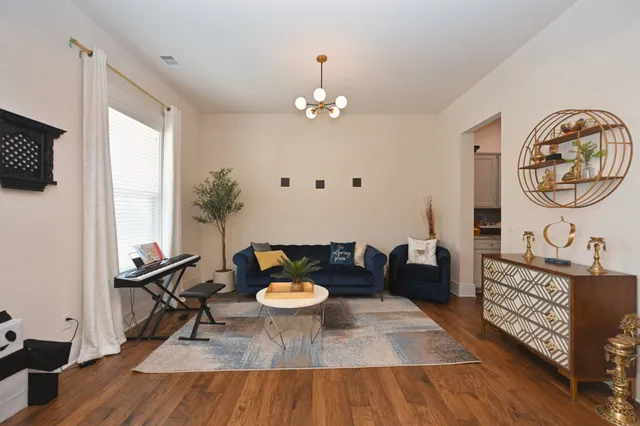 a living room with furniture and a wooden floor