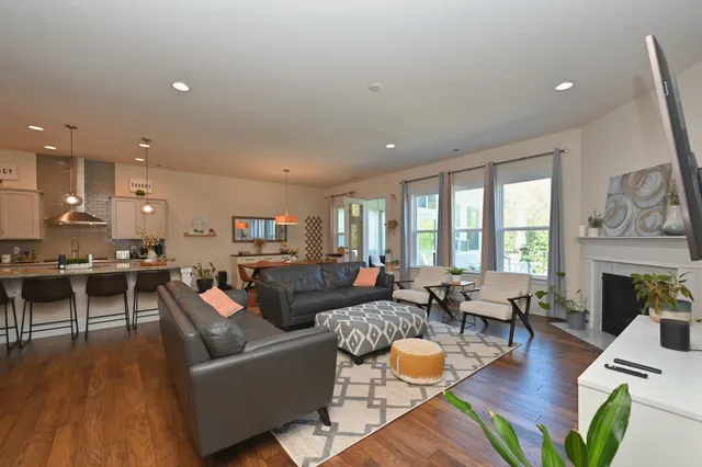 a large kitchen with kitchen island a stove a sink a oven and a dining table