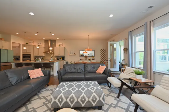 a dining room with furniture a fireplace and a chandelier