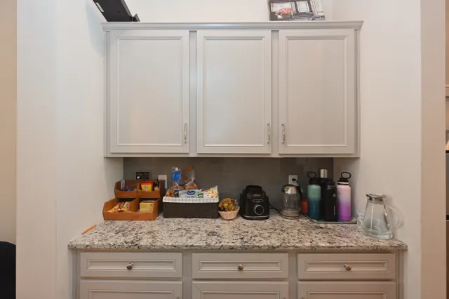 a spacious bathroom with a granite countertop sink and a mirror
