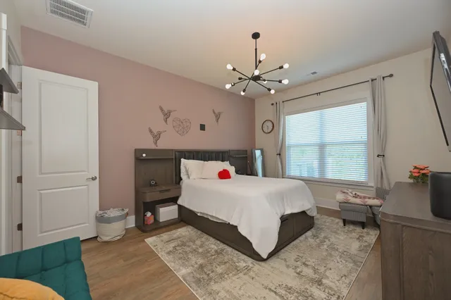 a bedroom with a bed and a window