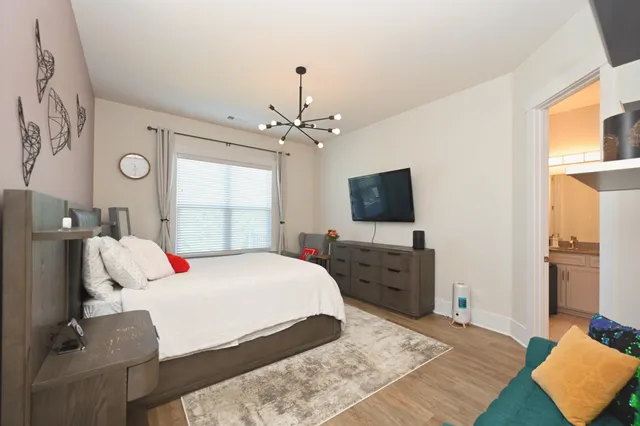 a bedroom with a bed and a potted plant