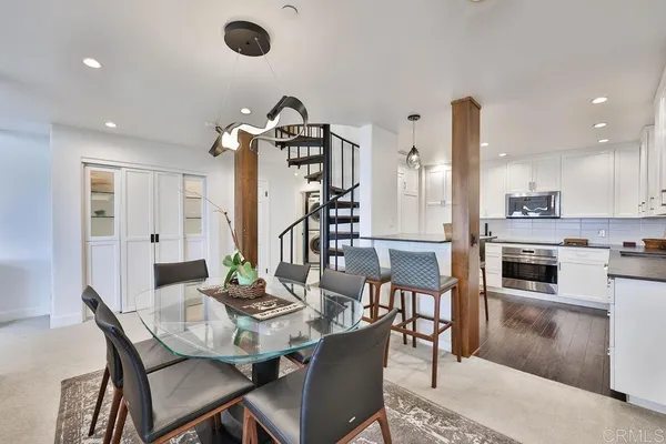 a view of a dining room with furniture and wooden floor