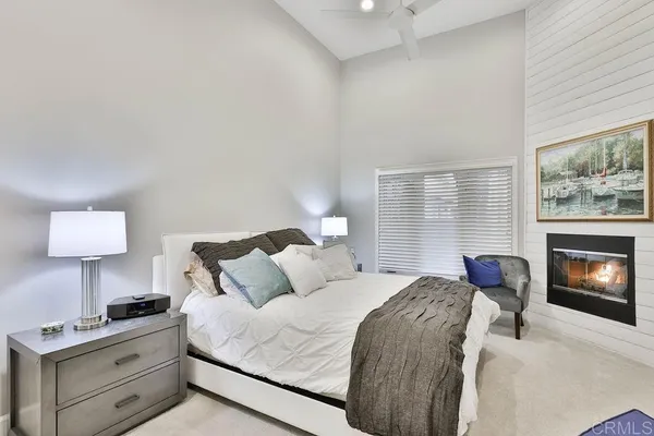 a bedroom with a bed and a fireplace