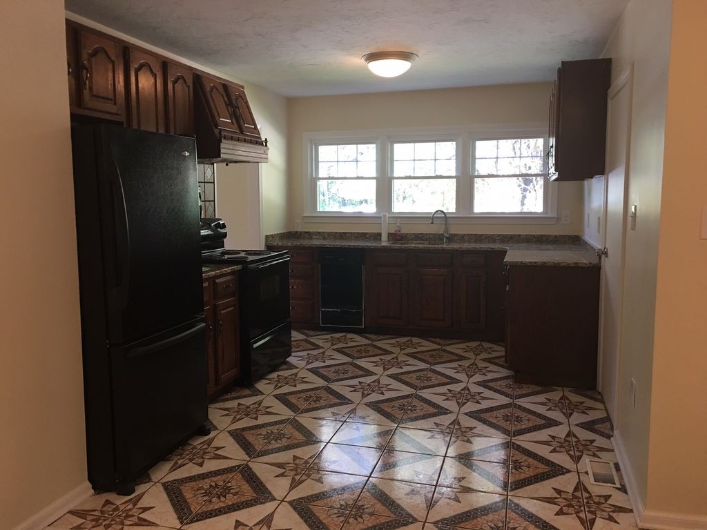 154 New Boston Road Sturbridge, MA 01566 - Photo 10 of 29 a kitchen with a refrigerator and window