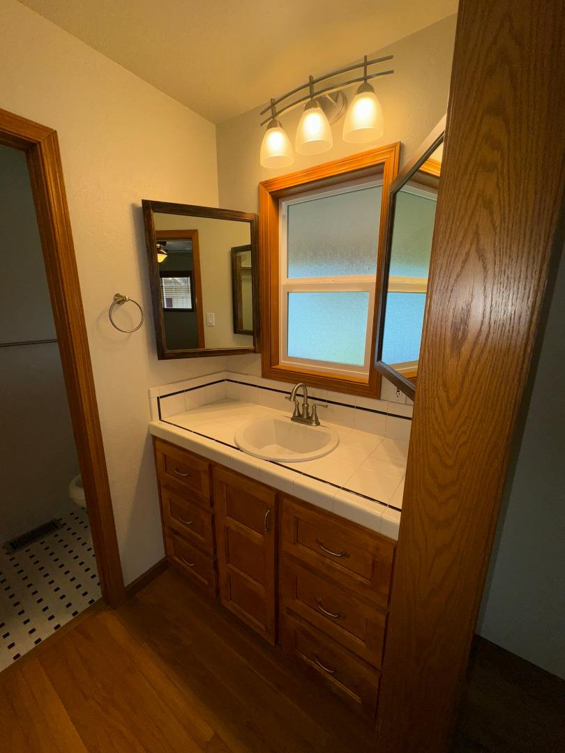 451 Corral De Tierra Road Salinas, CA 93908 - Photo 32 of 55 a bathroom with a sink and a mirror