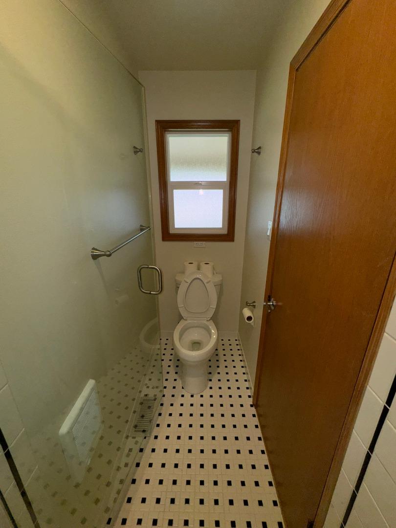 451 Corral De Tierra Road Salinas, CA 93908 - Photo 34 of 55 a bathroom with a toilet and a shower curtain