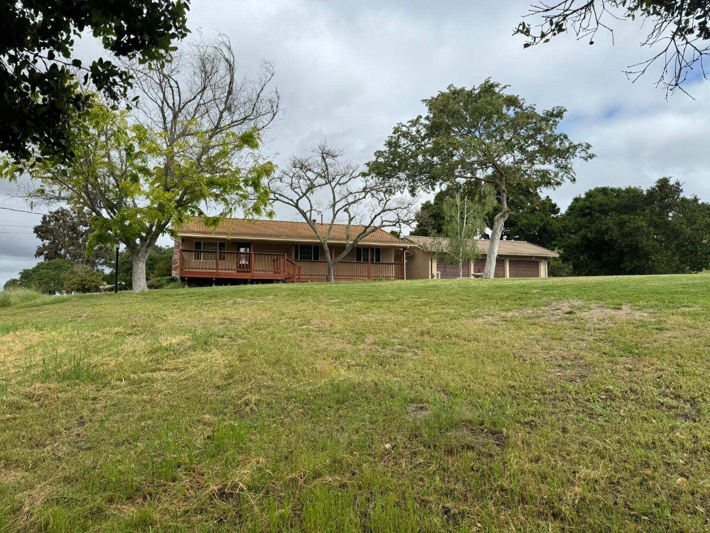 451 Corral De Tierra Road Salinas, CA 93908 - Photo 7 of 55 a front view of a house with a garden and trees