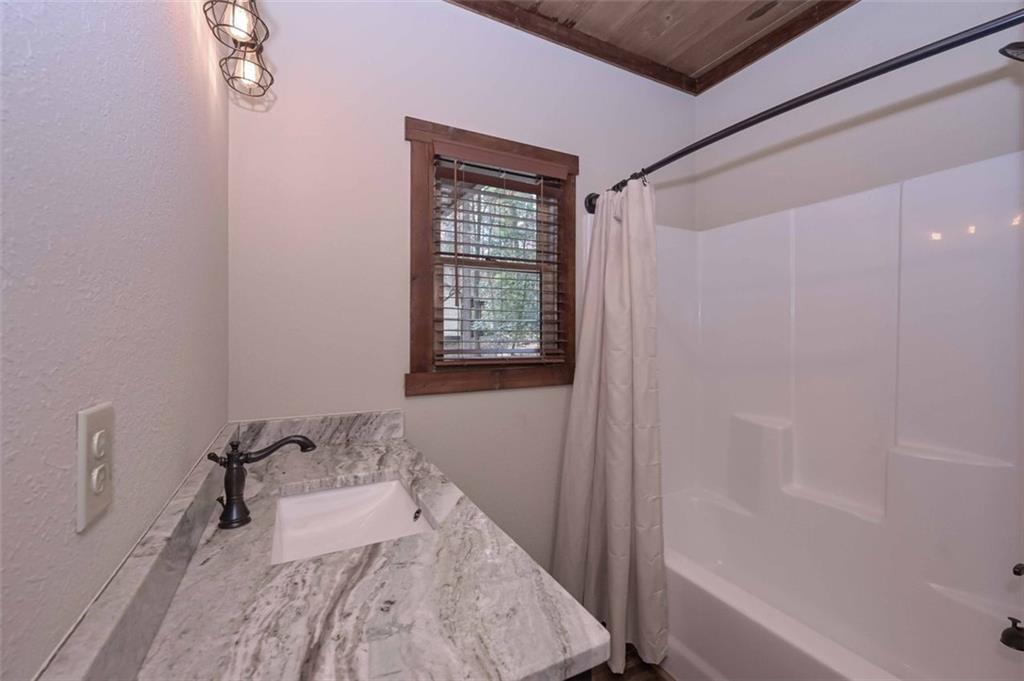 110 Ridge Crest Court Ellijay, GA 30540 - Photo 11 of 33 a bathroom with a tub sink and mirror