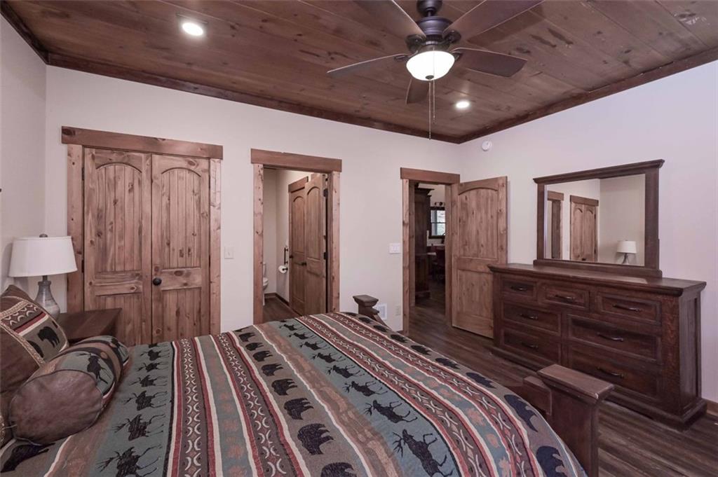 110 Ridge Crest Court Ellijay, GA 30540 - Photo 14 of 33 a bedroom with a bed and a chandelier