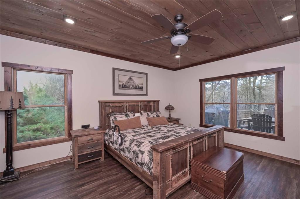 110 Ridge Crest Court Ellijay, GA 30540 - Photo 15 of 33 a bed sitting in a spacious bedroom next to a window