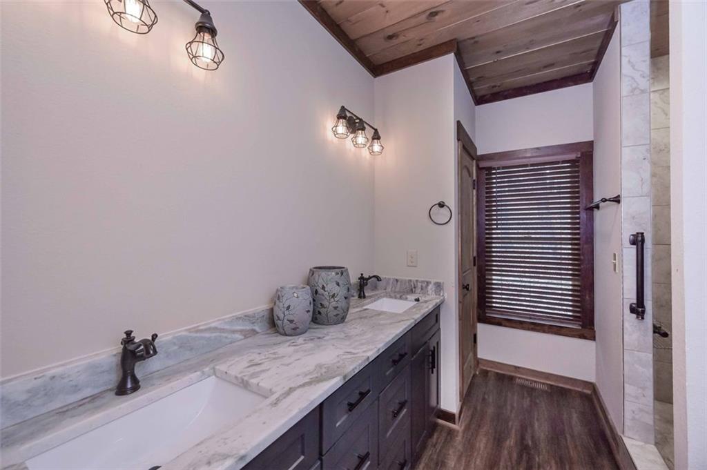 110 Ridge Crest Court Ellijay, GA 30540 - Photo 17 of 33 a bathroom with a granite countertop sink and a wooden floor