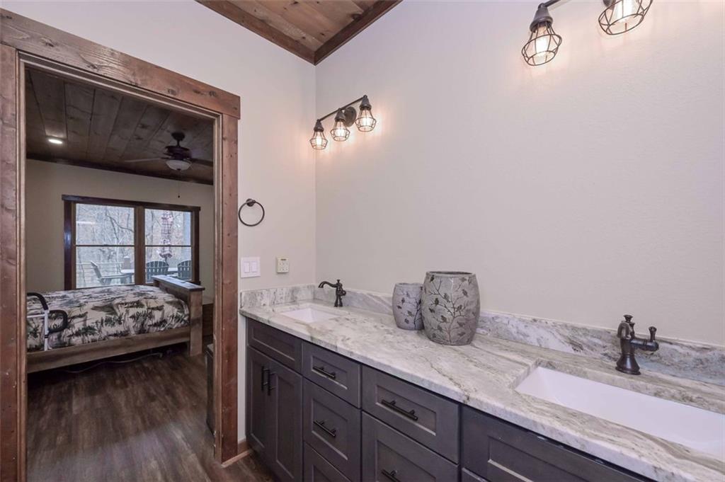 110 Ridge Crest Court Ellijay, GA 30540 - Photo 22 of 33 a en suite bathroom with a granite countertop sink and a mirror