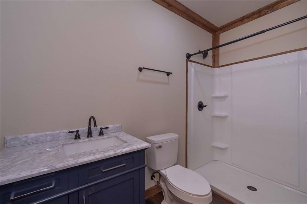 110 Ridge Crest Court Ellijay, GA 30540 - Photo 28 of 33 a bathroom with a granite countertop sink toilet and shower