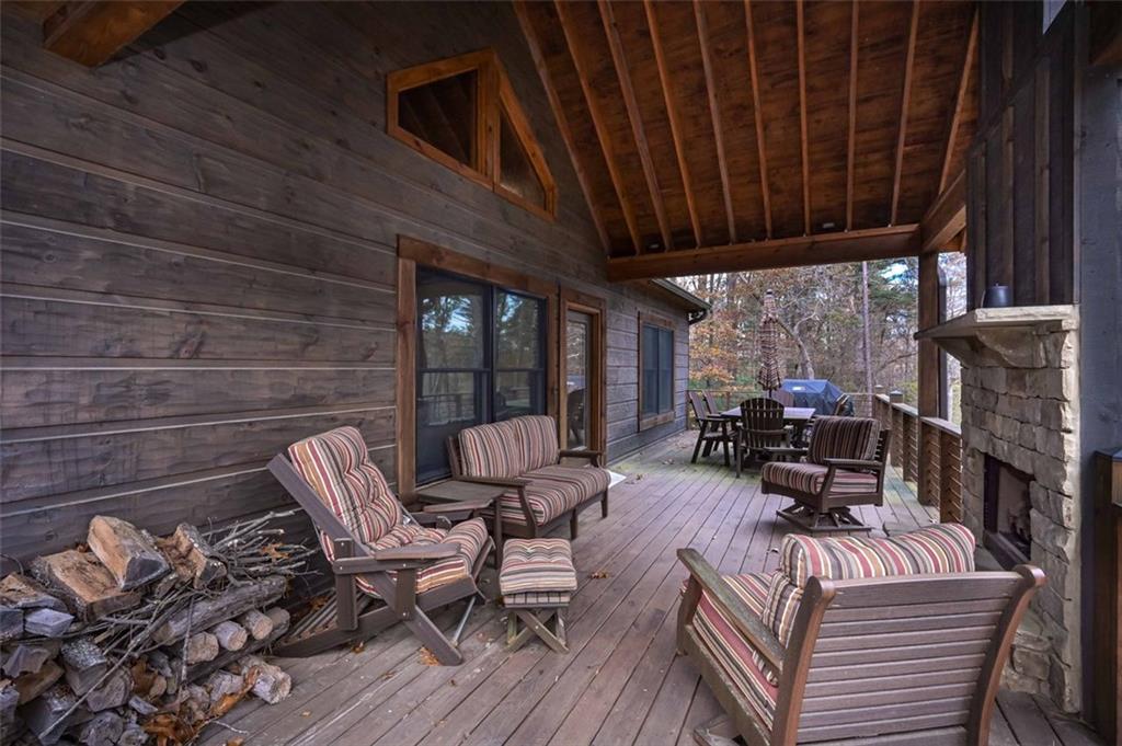 110 Ridge Crest Court Ellijay, GA 30540 - Photo 29 of 33 a view of a patio with table and chairs with wooden floor and fence