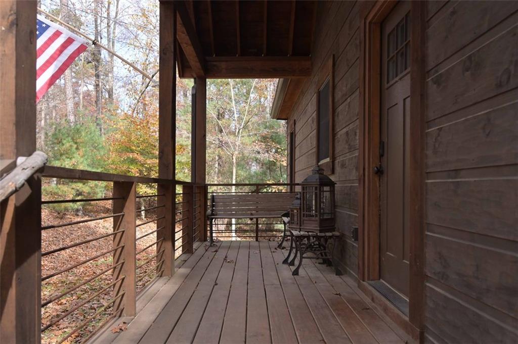 110 Ridge Crest Court Ellijay, GA 30540 - Photo 5 of 33 a view of a balcony with chairs and wooden floor