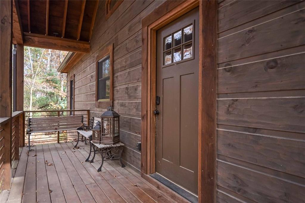 110 Ridge Crest Court Ellijay, GA 30540 - Photo 6 of 33 a view of a balcony with chairs and wooden floor