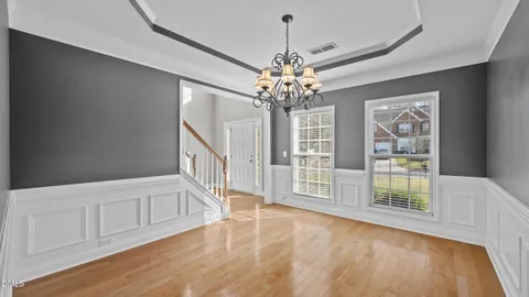 a view of a livingroom with a chandelier fan