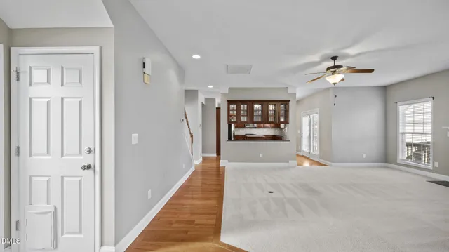 a view of an empty room with a fireplace and a window