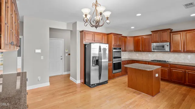 a view of an empty room with a fireplace and a window