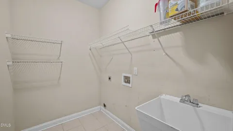 a kitchen with a sink refrigerator and cabinets