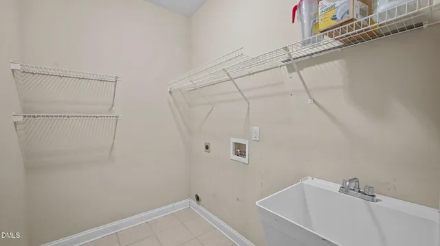 a kitchen with a sink refrigerator and cabinets