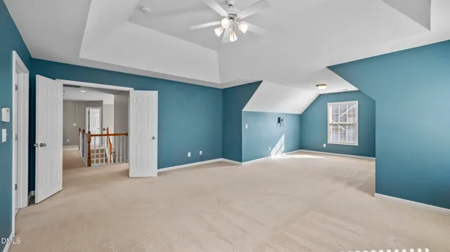 a view of an empty room with cabinet and a window