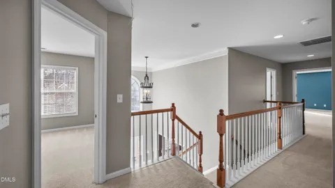 a view of a hallway with windows and stairs