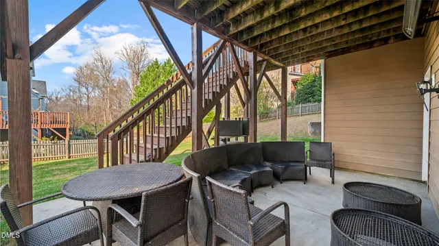 a balcony with table and chairs