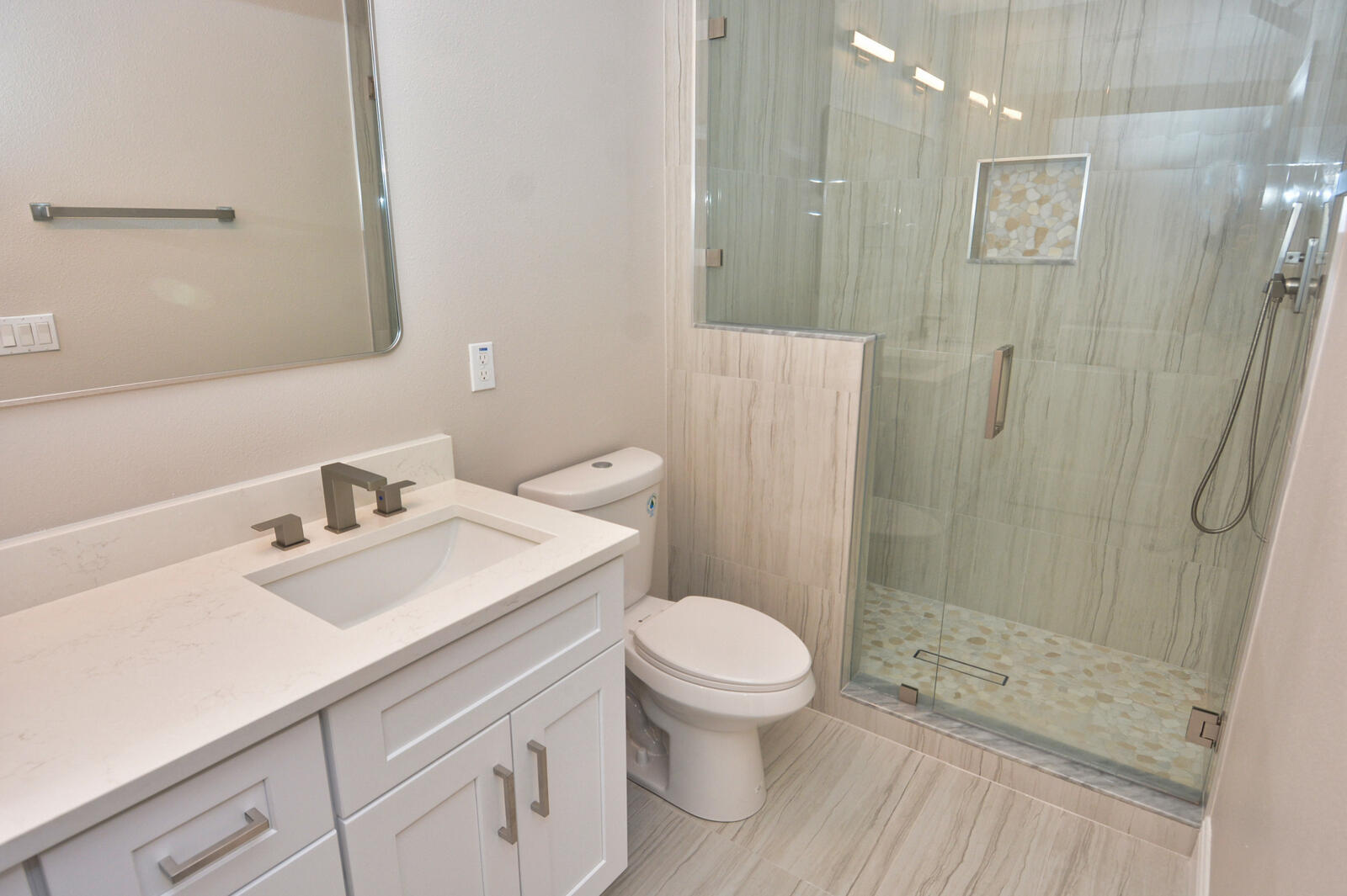 3524 Carriage Pointe Circle Fort Pierce, FL 34981 - Photo 16 of 55 a bathroom with a sink toilet a mirror and shower